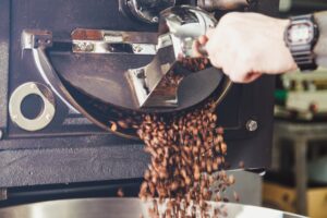 Coffee beans pouring from a roaster, representing Brisbane coffee