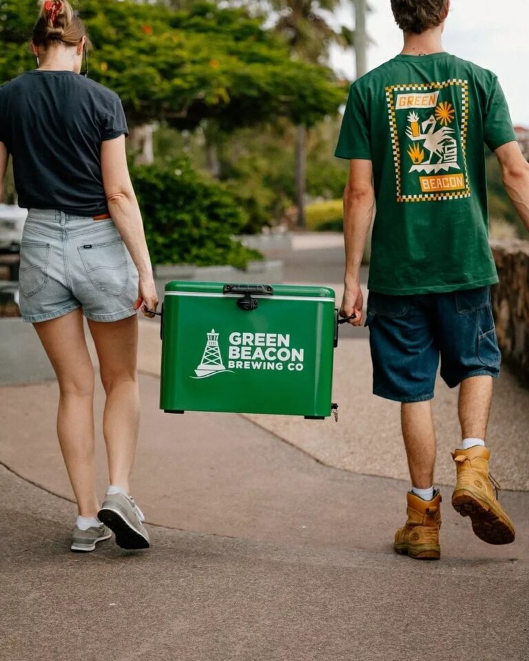 Green Beacon Teneriffe brand esky carried along a footpath by two people