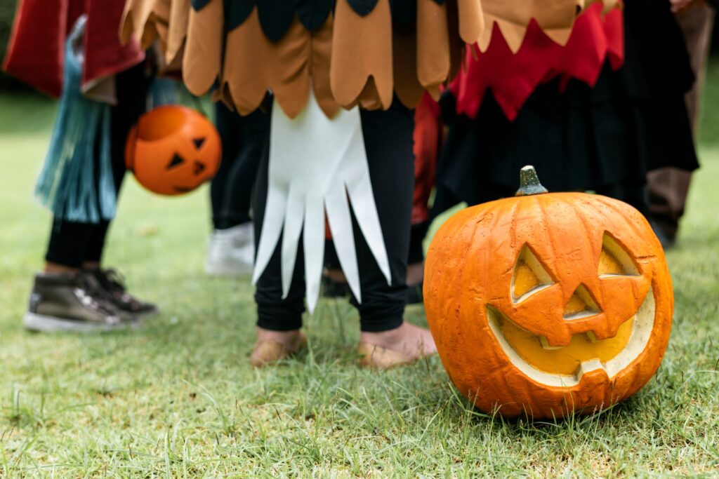 Carved pumpkin and children in costumes ahead of the Halloween weekend Brisbane events